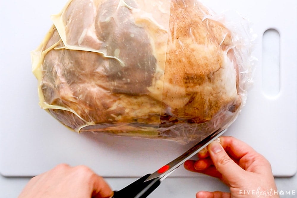 Boneless ham for crockpot being removed from packaging.