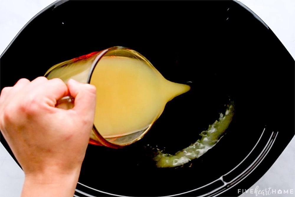 Pouring pineapple juice into slow cooker.