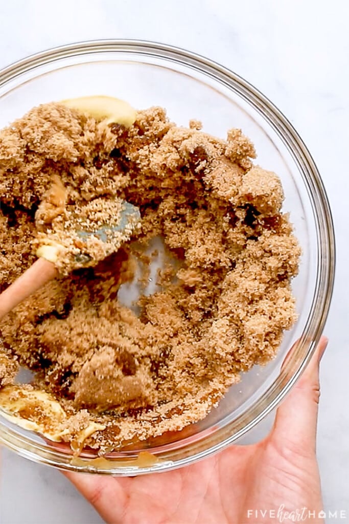 Mixing brown sugar with other ingredients to make glaze.