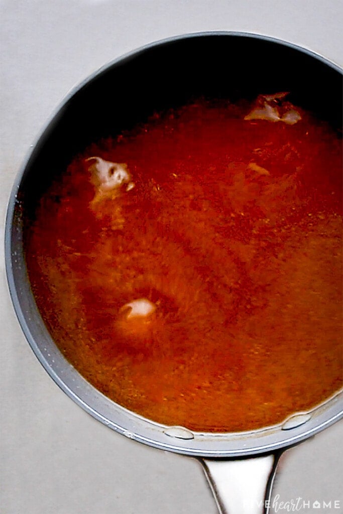 Brown sugar ham glaze bubbling in pot.