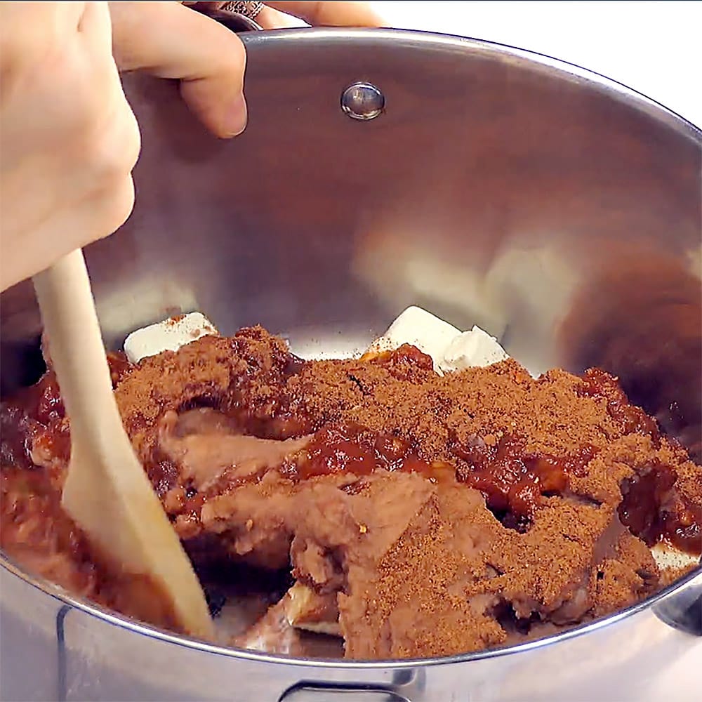 Stirring ingredients together with wooden spoon.