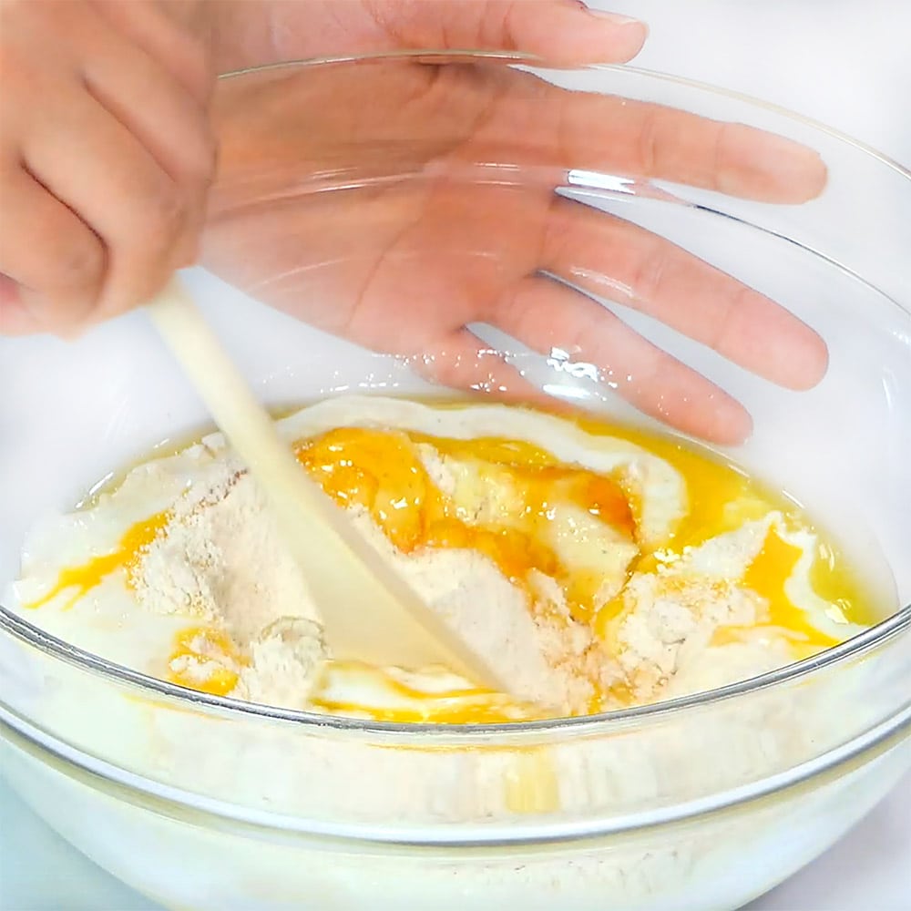 Stirring together ingredients with wooden spoon.