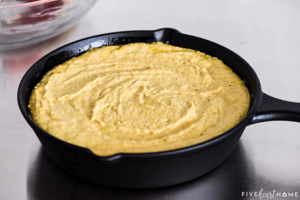 Batter spread into skillet.