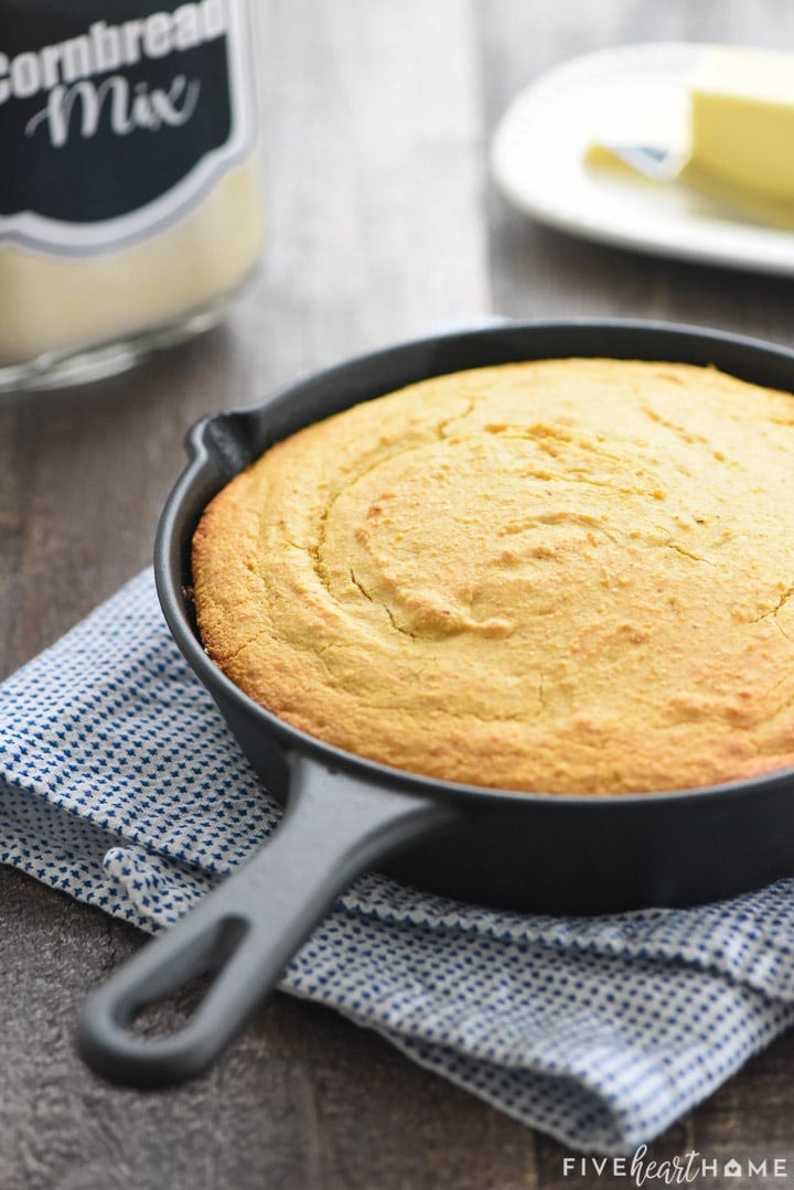 Skillet of cornbread with jar of Cornbread Mix in background.