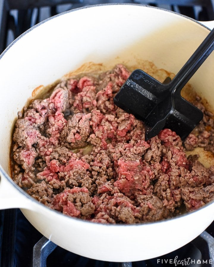 Cooking ground beef in pot.