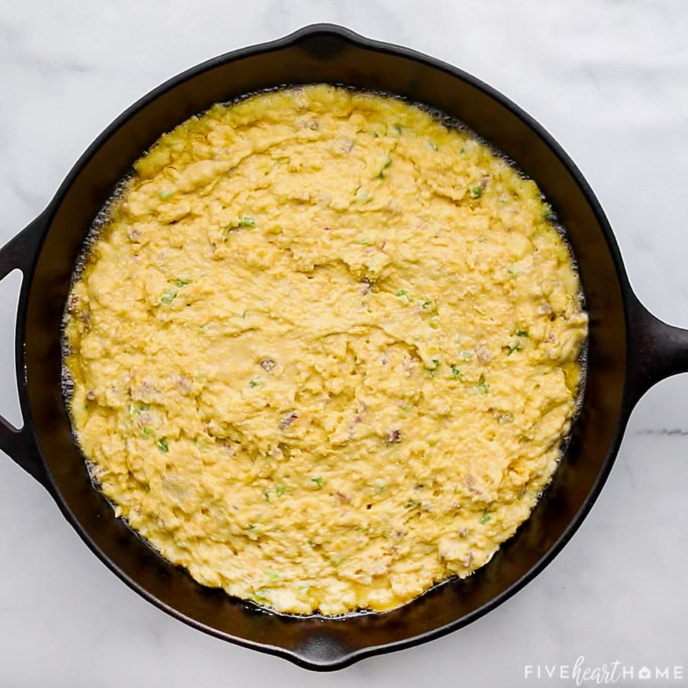 Batter spread into cast iron skillet.