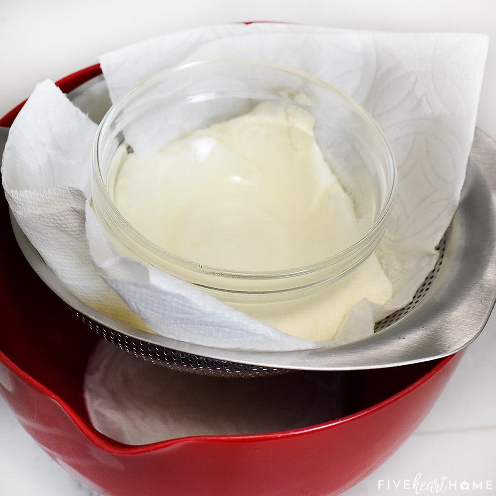 Draining ricotta over lined strainer.