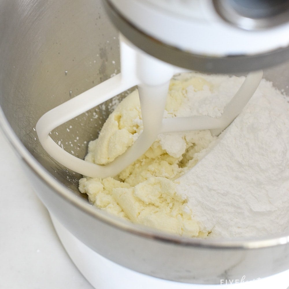 Blending ricotta and powdered sugar.