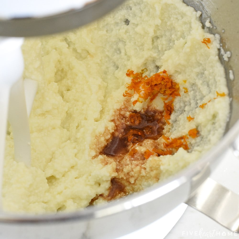 Adding vanilla and orange zest to bowl.