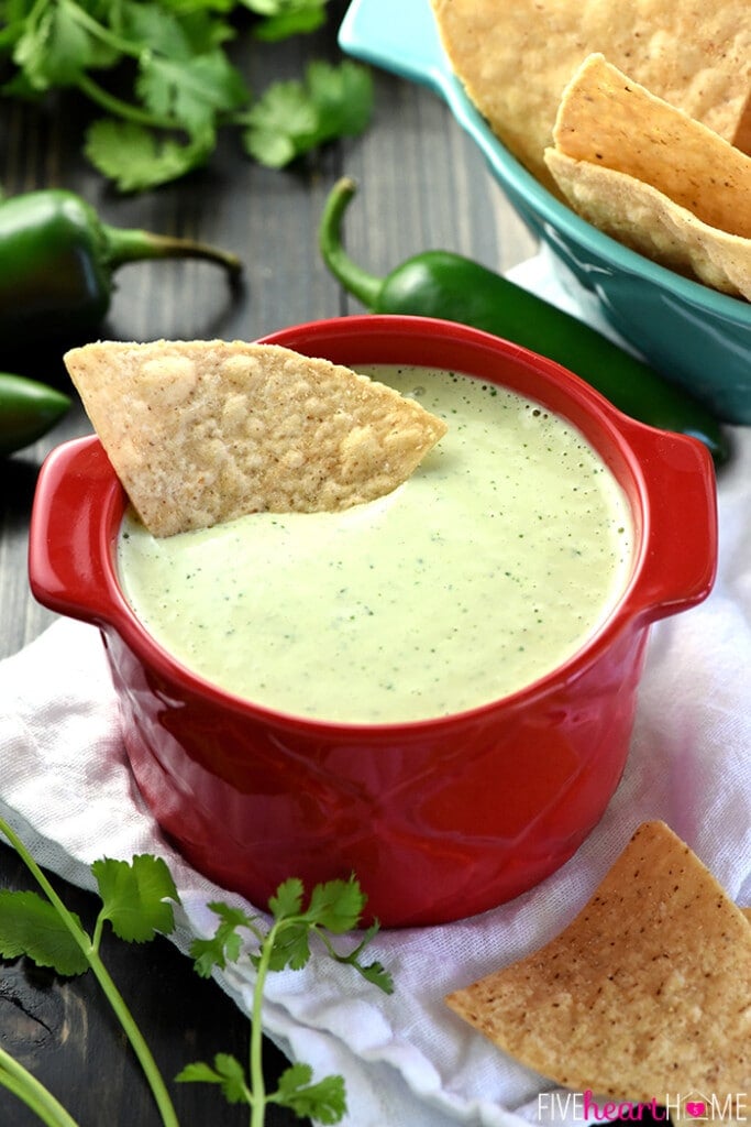 Chuy's Creamy Jalapeño Dip with tortilla chip dipped.