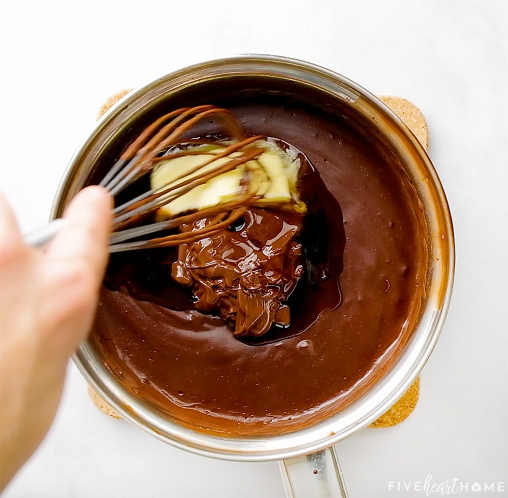 Adding butter and melted chocolate to chocolate pudding recipe.