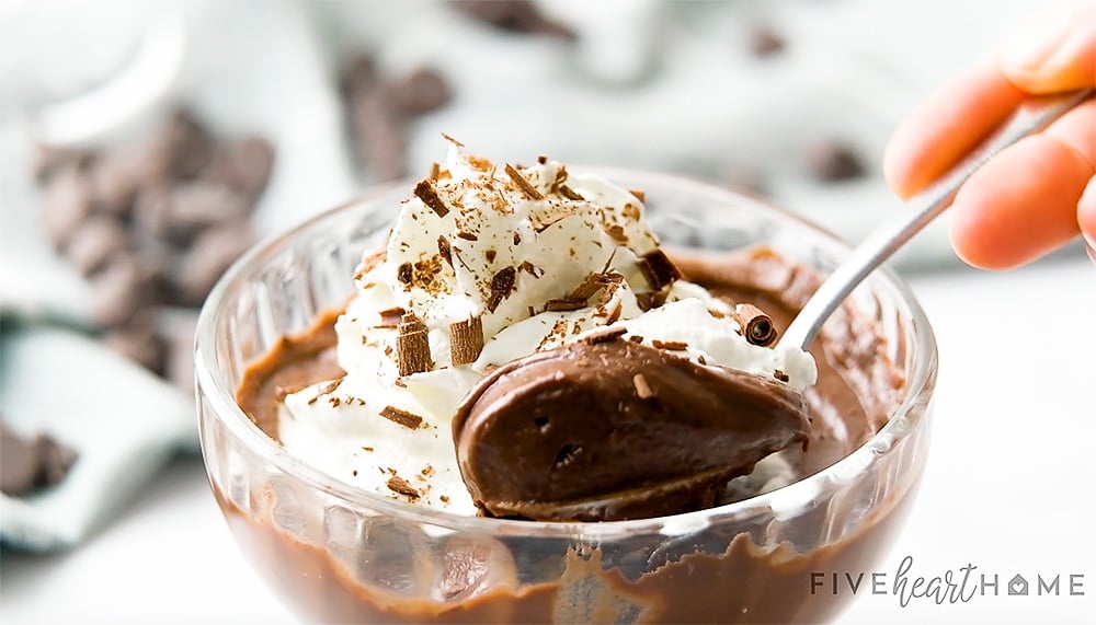 Spoonful of chocolate pudding recipe in glass.