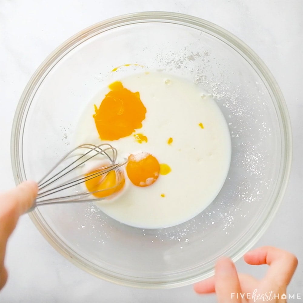 Whisking egg yoks, milk, cornstarch, and salt.