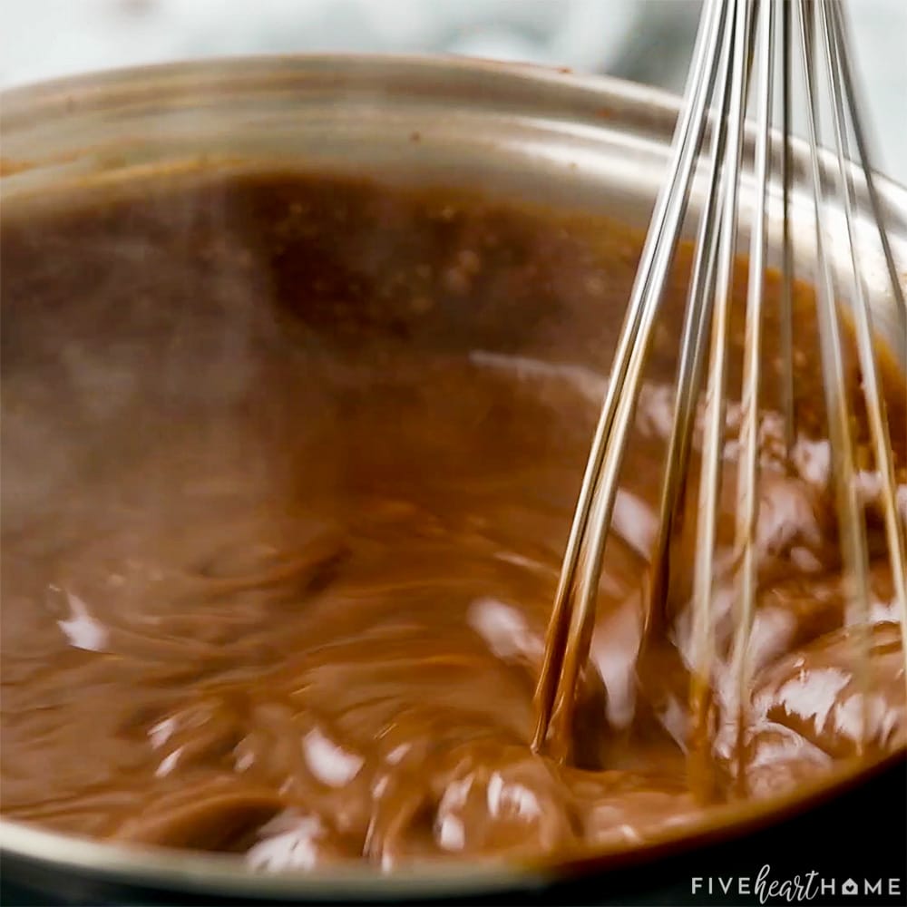 Close-up of whisking in pot on stove.