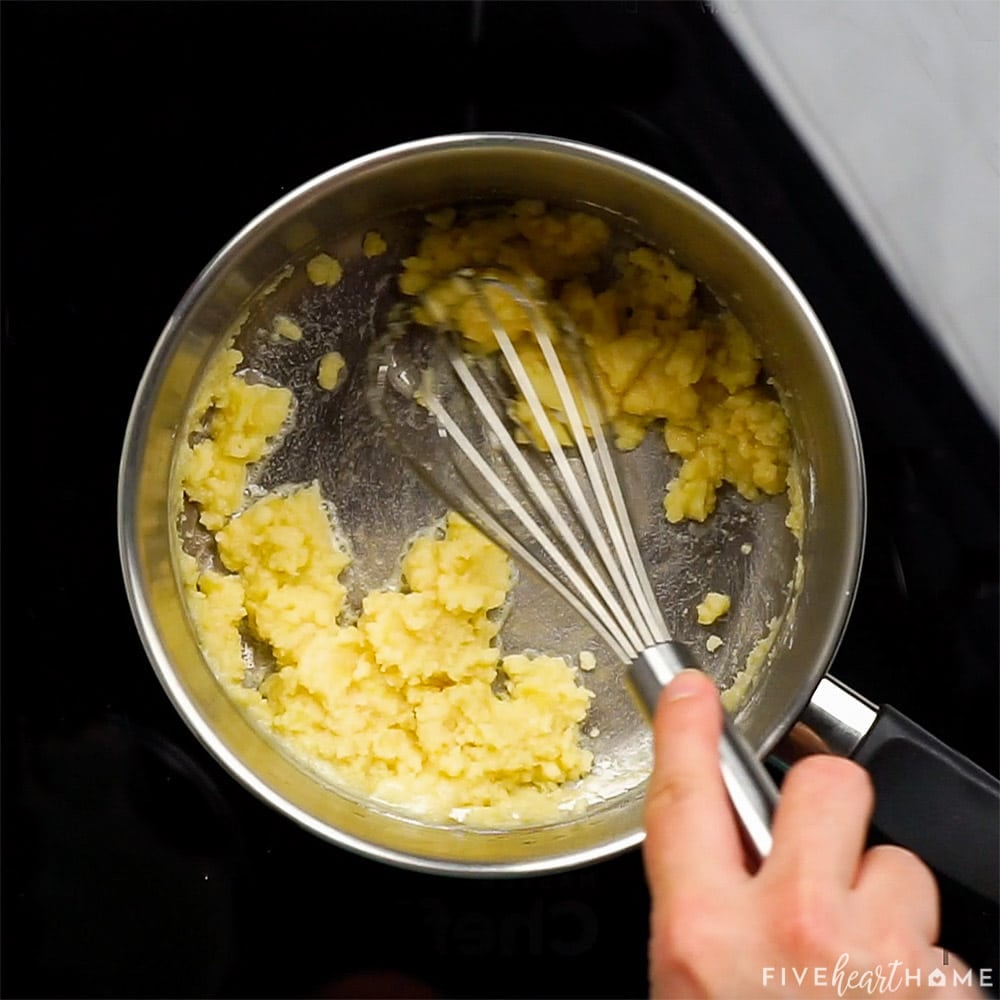 Whisking together butter and flour.