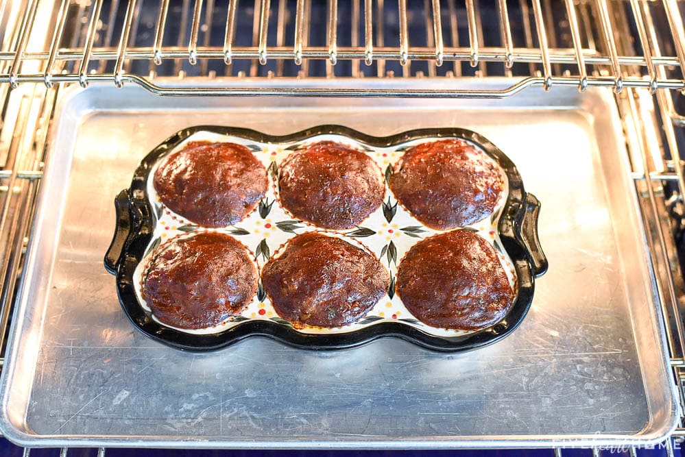 Baked Meatloaf Muffins in pan in oven.