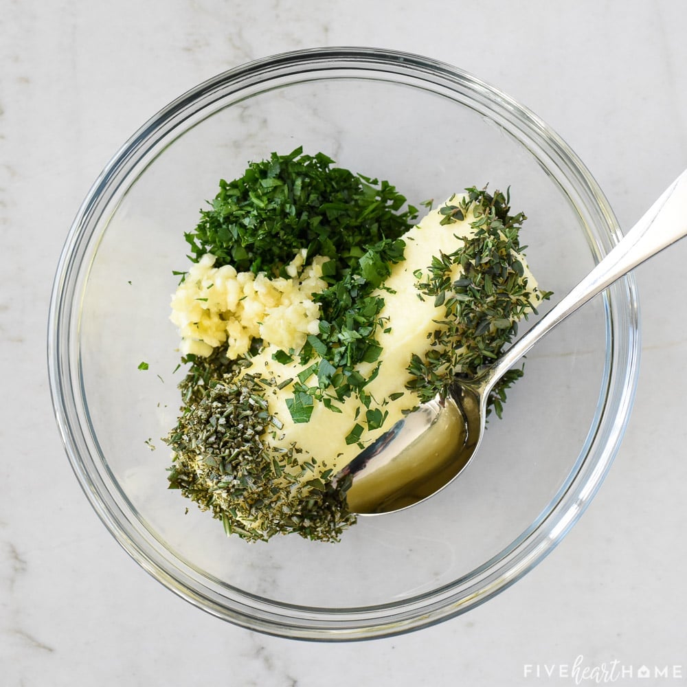 Herb butter ingredients in bowl.