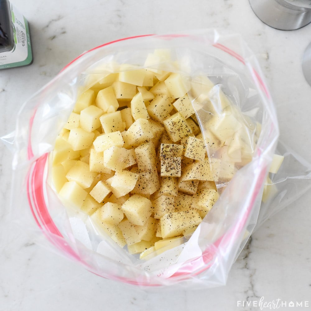 Cubed potatoes in bag with seasoning.