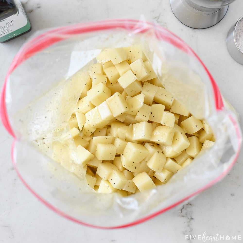 Seasoned potatoes ready to roast.