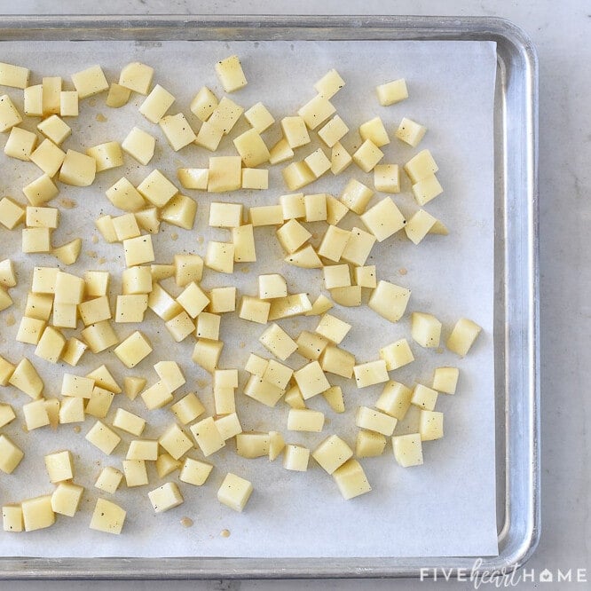 Potatoes on pan ready for oven.