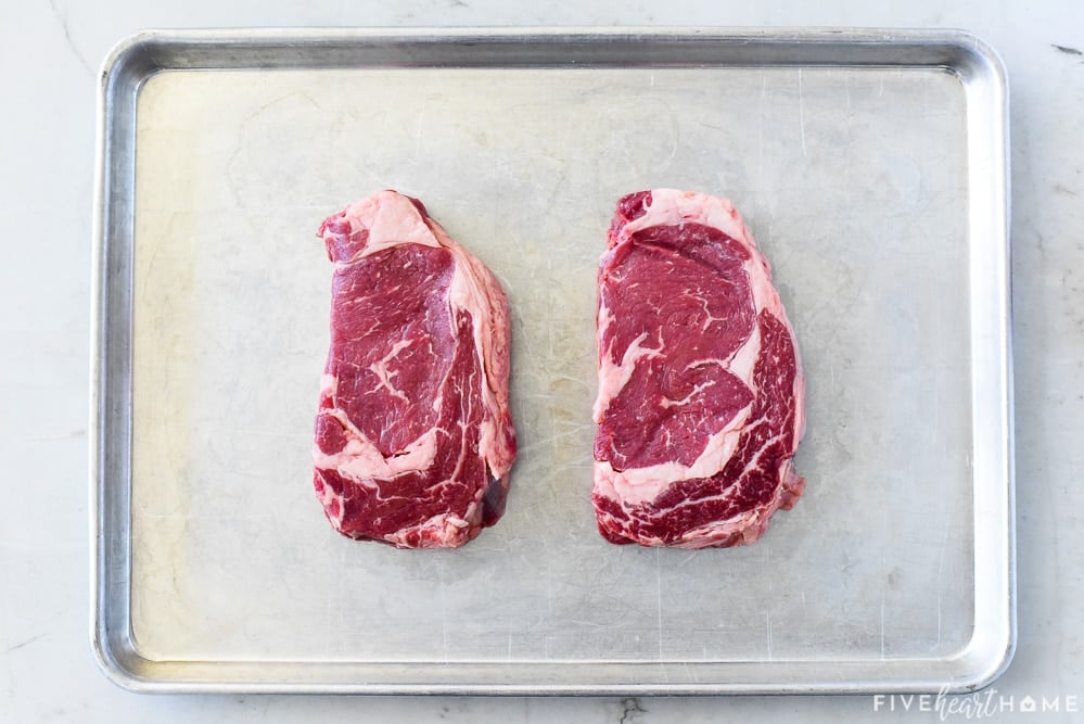 Aerial view of ribeyes on sheet pan.