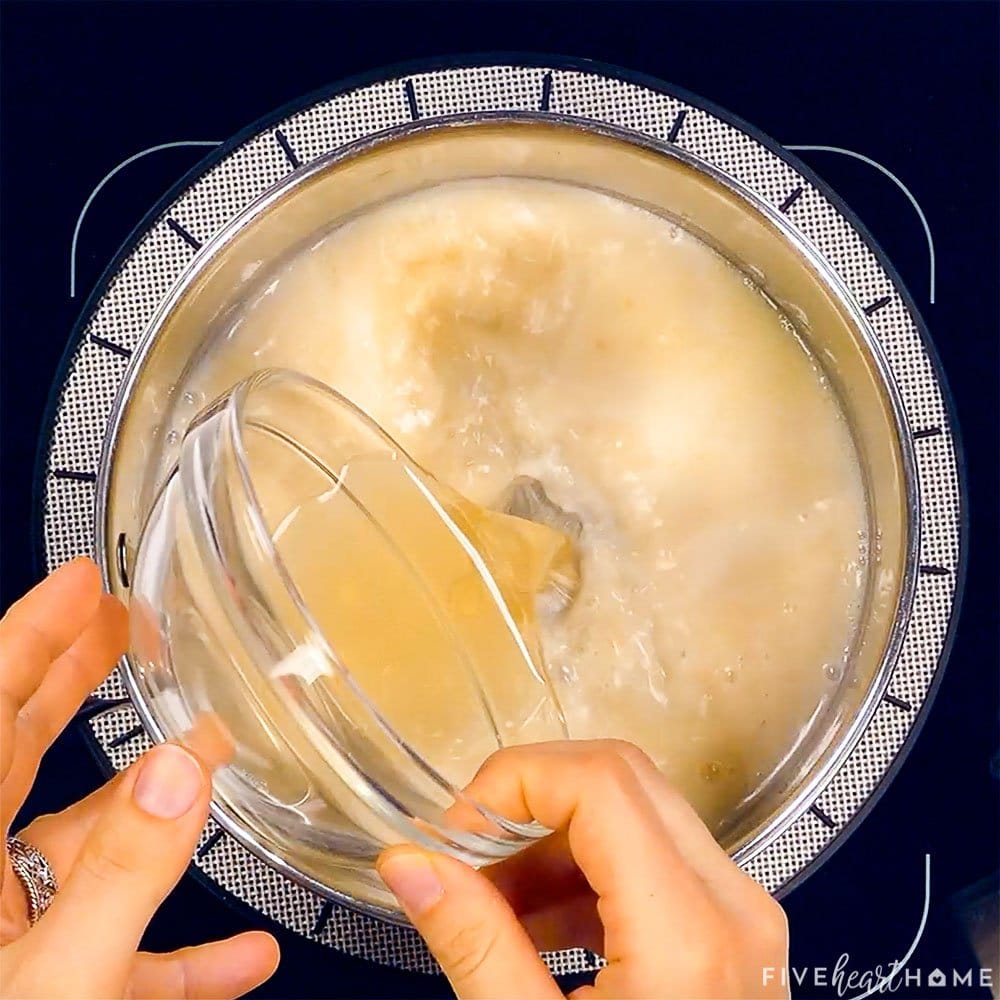 Broth being poured into mixture.