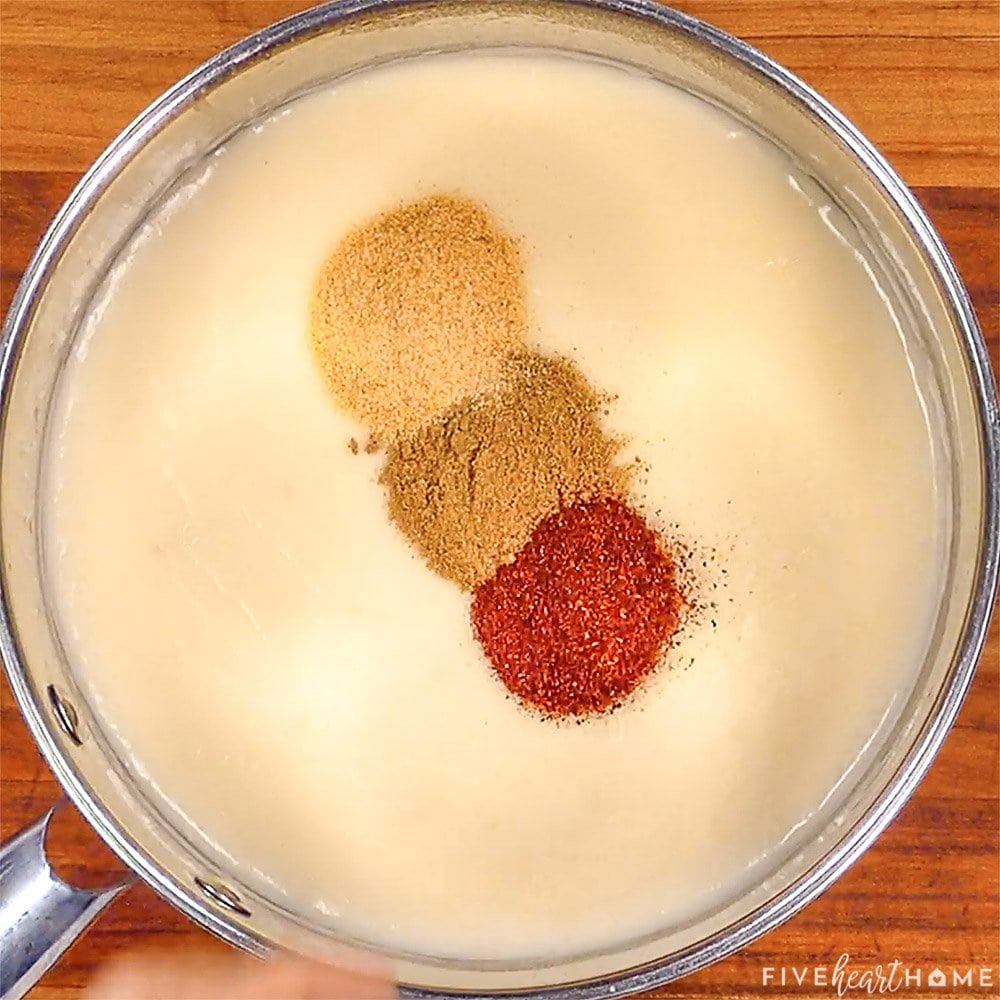 Adding spices to homemade sauce.