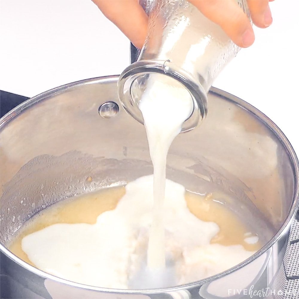 Milk being poured into pot.