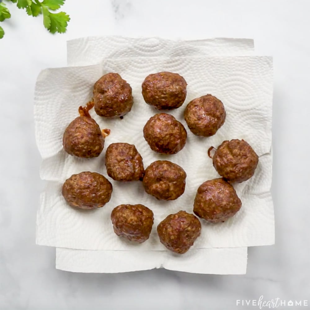 Meatballs draining on paper towels.