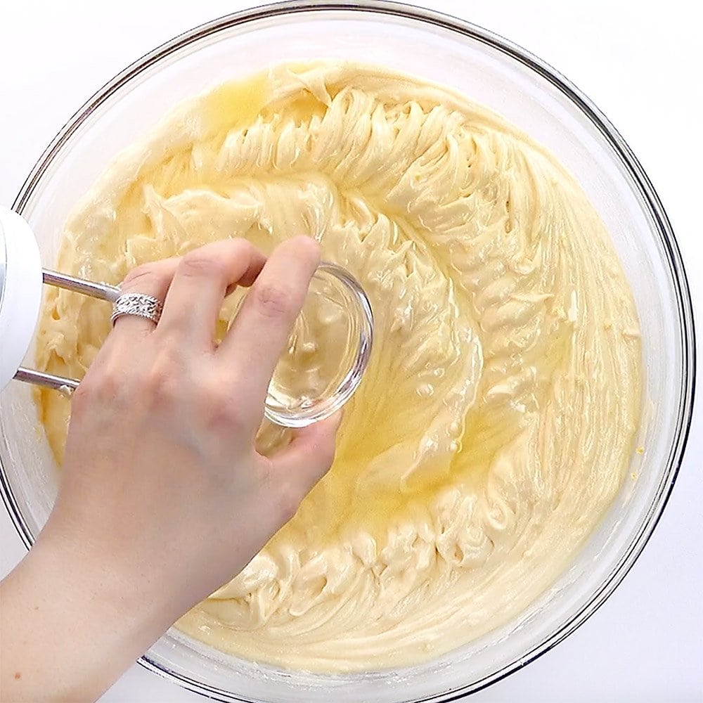 Adding lemon juice and lemon extract to bowl.