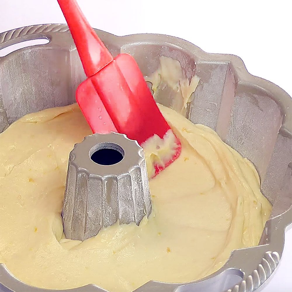 Smoothing out batter with a spatula.