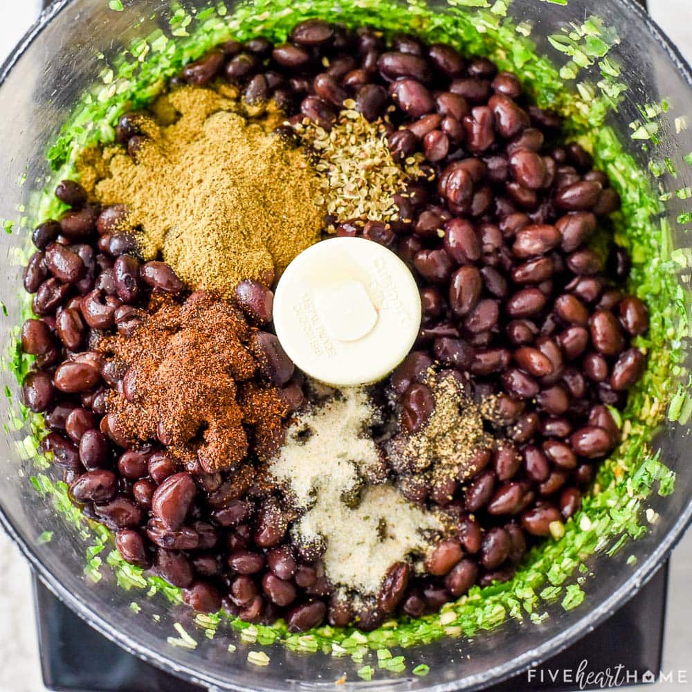 Adding black beans and spices to food processor.