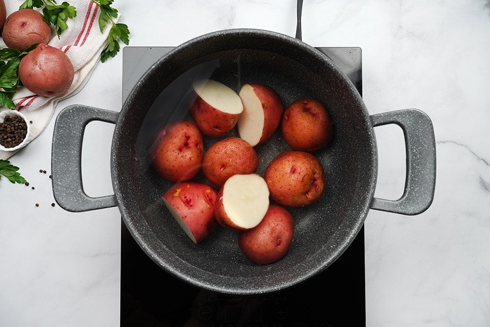 Red potatoes in pot of water ready to boil.