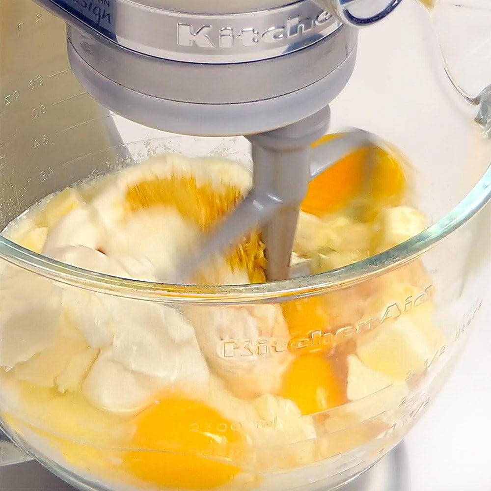 Combining lemon cupcake ingredients in electric stand mixer.