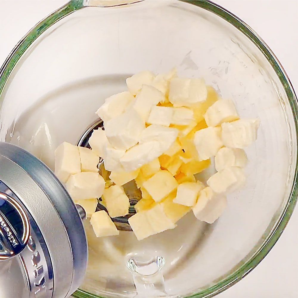 Combining cream cheese and butter in bowl.