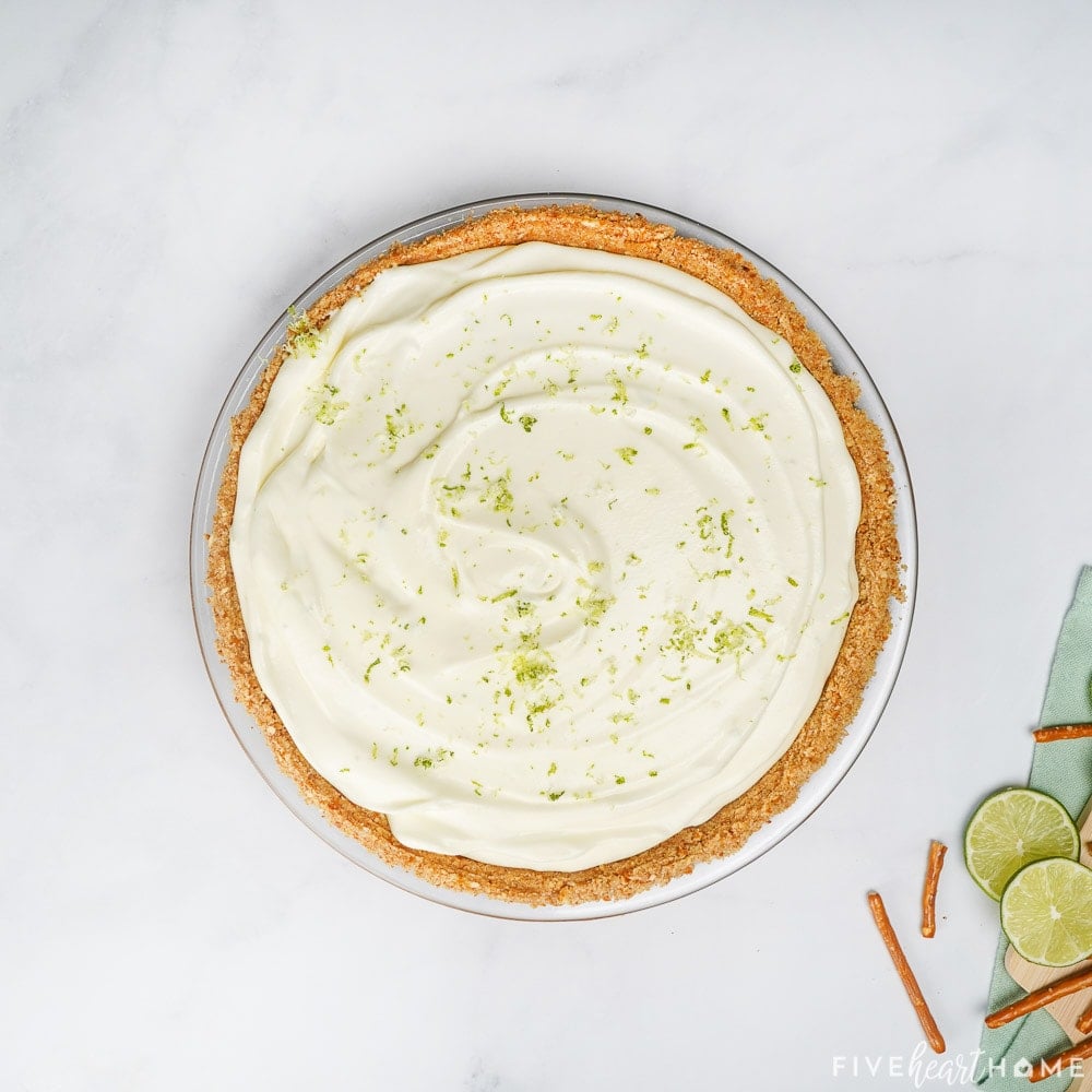 Garnishing the top of the Margarita Pie with lime zest.