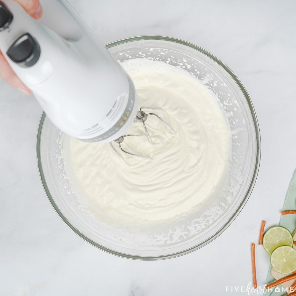 Beating whipped cream in a bowl.