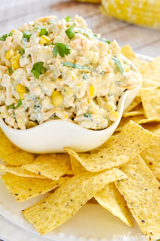 Bowl of Corn Dip surrounded by tortilla chips.