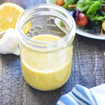 Champagne Vinaigrette in jar with salad.
