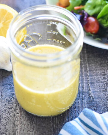 Champagne Vinaigrette in jar with salad.