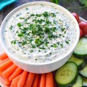 Greek Yogurt Dip in white bowl surrounded by veggie dippers.