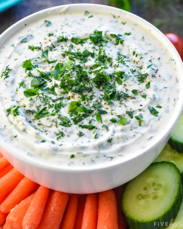Greek Yogurt Dip in white bowl surrounded by veggie dippers.