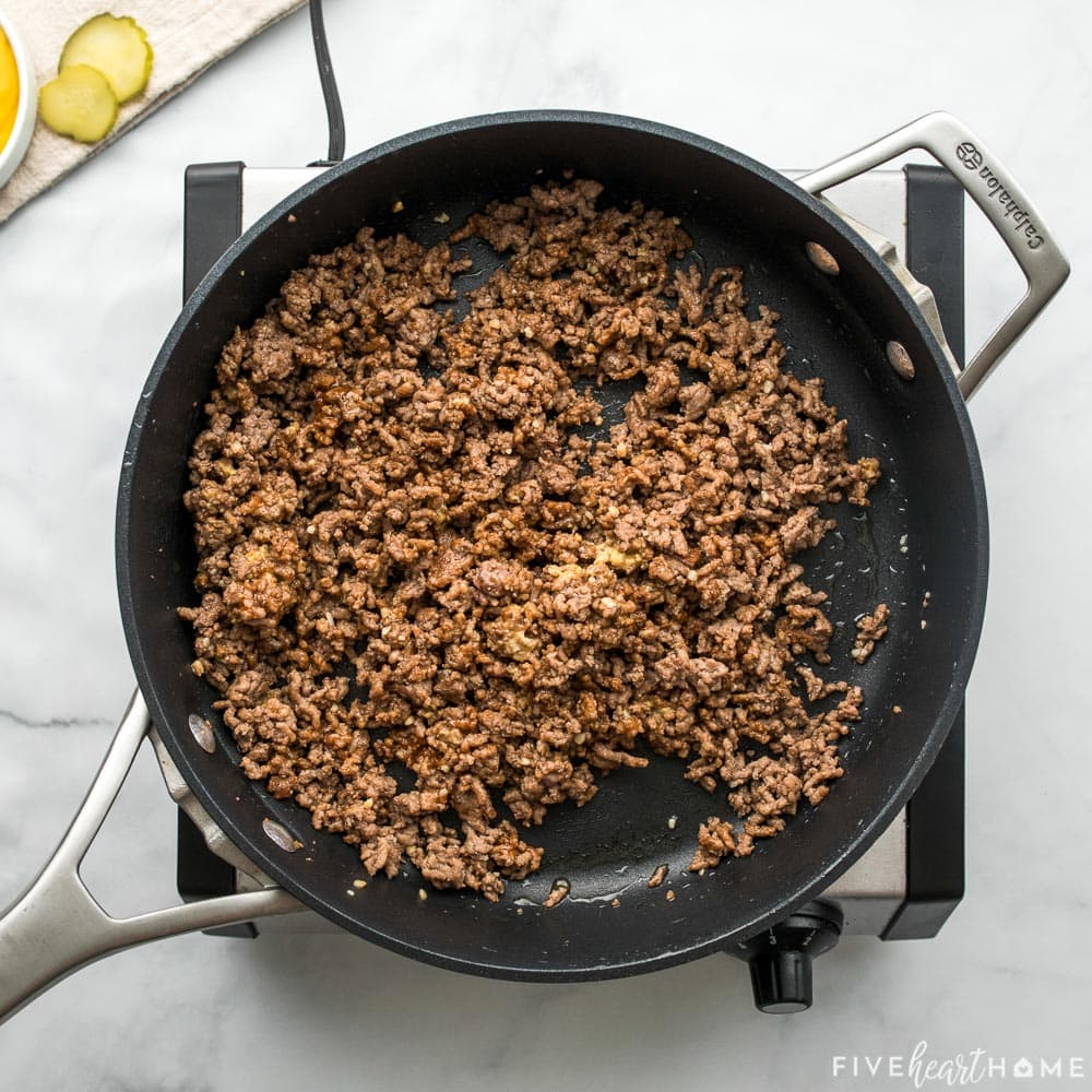 Ground beef cooked in skillet.
