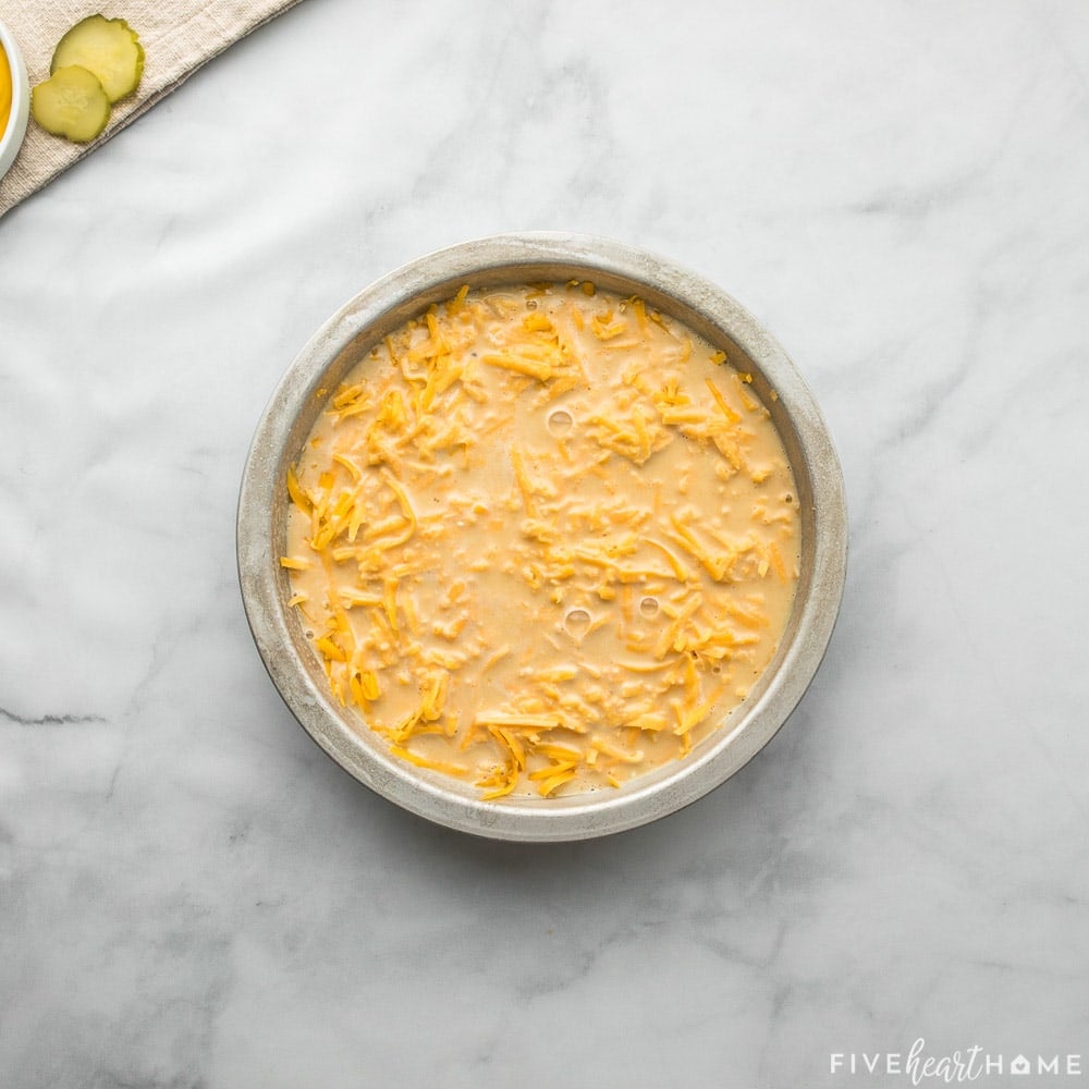 Batter poured over beef and cheese in dish.