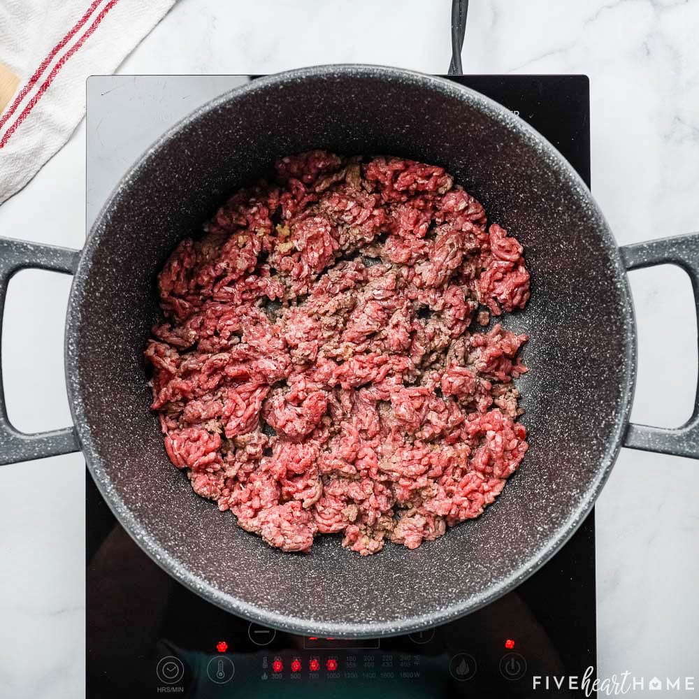 Ground beef cooking in pot.