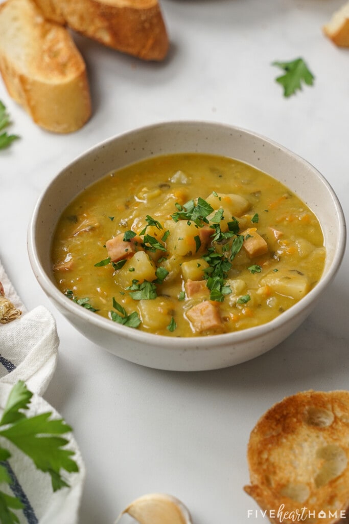 Bowl of Slow Cooker Split Pea Soup with ham, potatoes, and carrots.