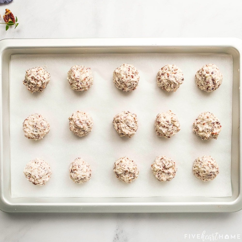 Mini Cheese Ball Bites arranged on pan, ready for rolling in nuts.