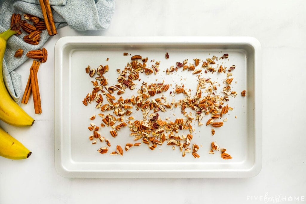 Chopped pecans on baking sheet for toasting.