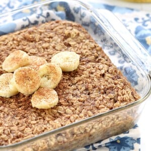 Banana Baked Oatmeal in glass dish with slices of bananas on top.