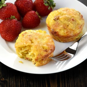 Frittata Muffins on a plate with fork and berries.